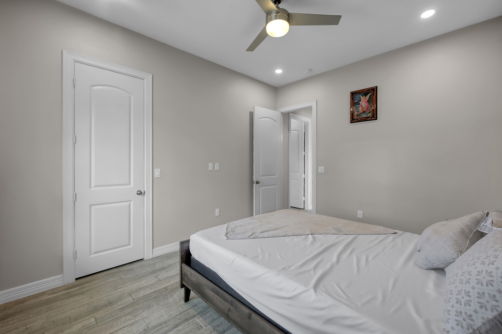 14609 Jim Stowe Road Conroe, TX 77302 - Photo 19 of 24 a bedroom with a bed and a chandelier