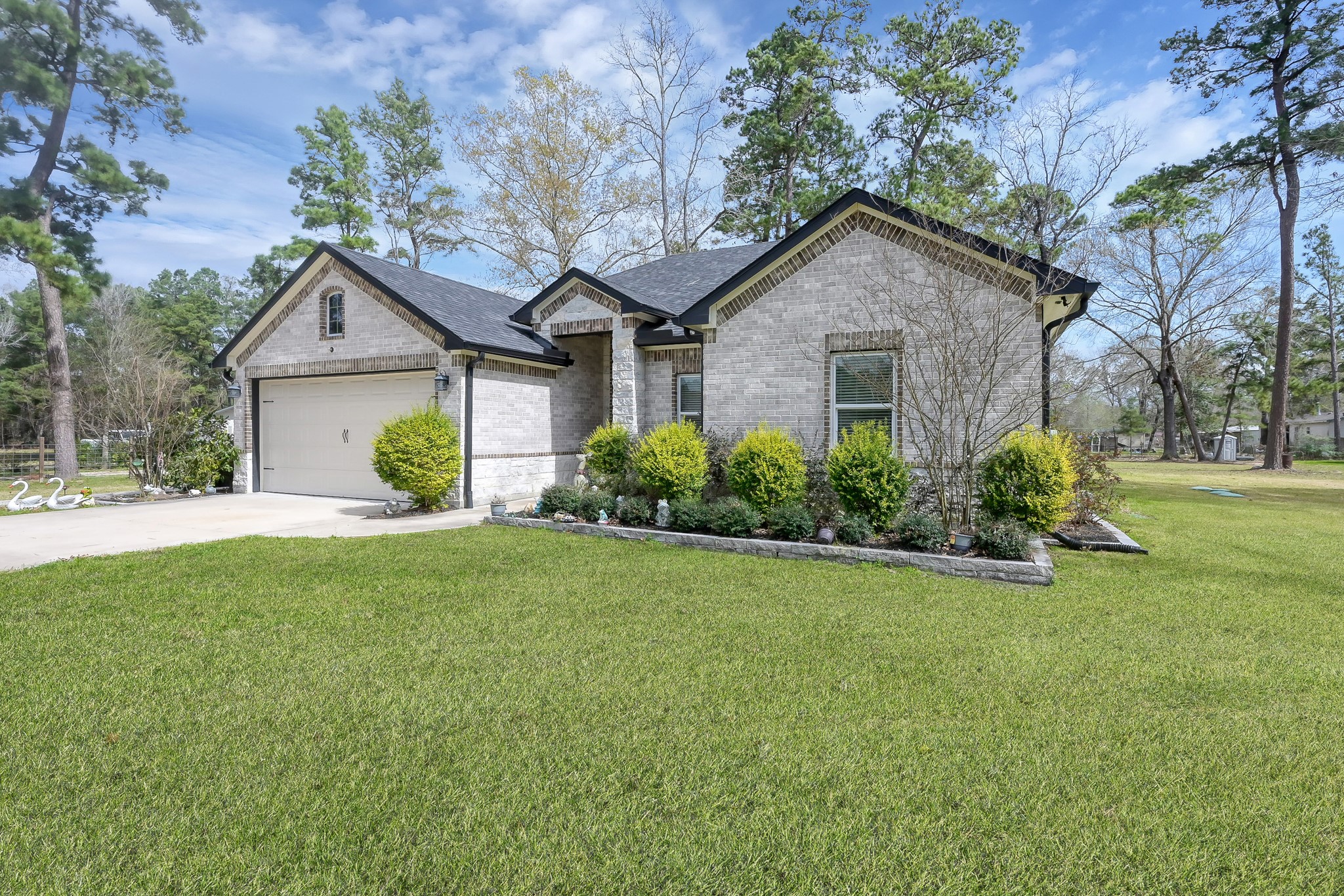 14609 Jim Stowe Road Conroe, TX 77302 - Photo 2 of 24 a house view with a garden space