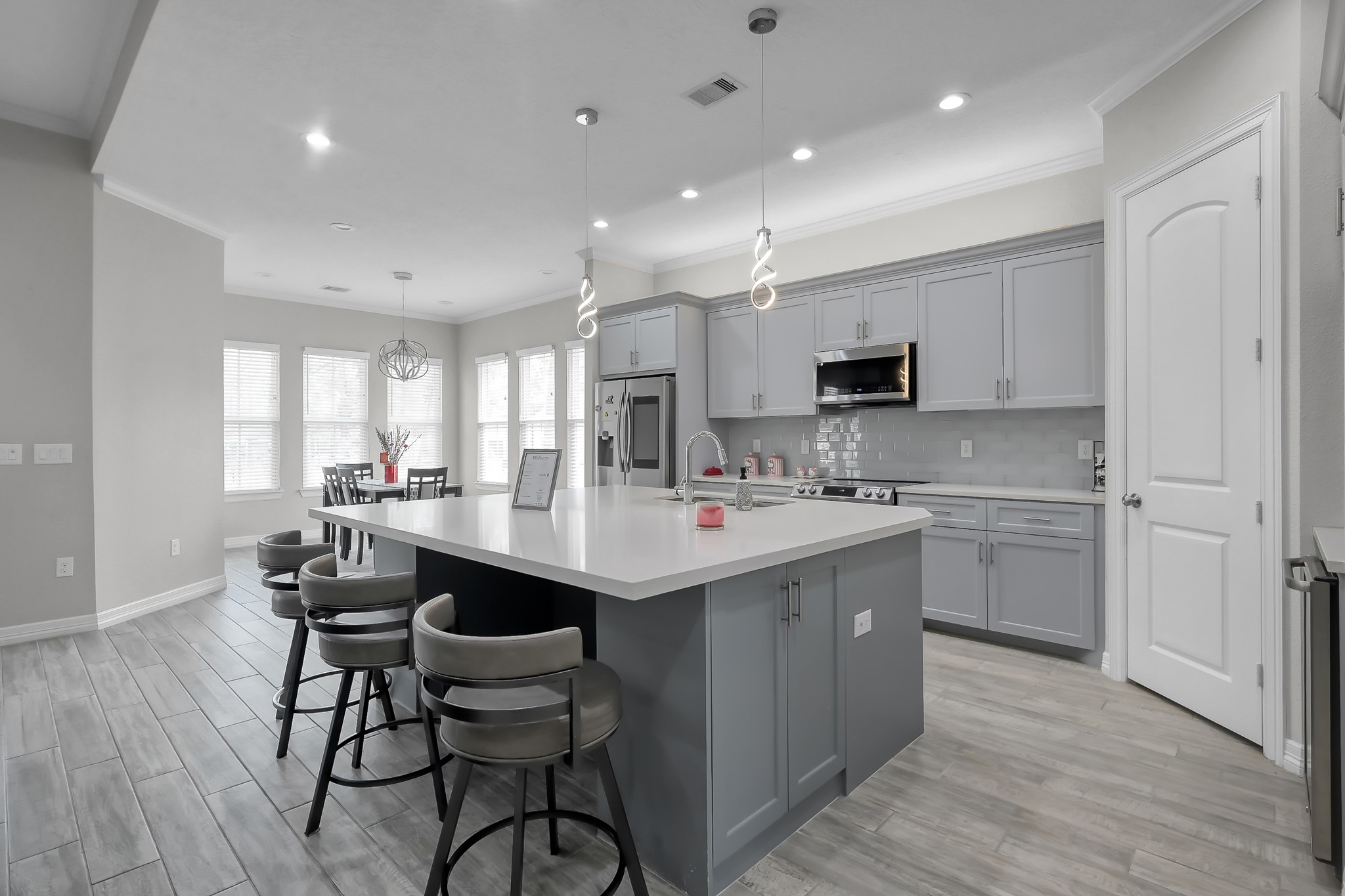 14609 Jim Stowe Road Conroe, TX 77302 - Photo 7 of 24 a kitchen with kitchen island a sink counter and chairs