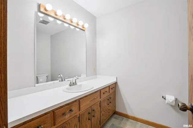 a bathroom with a sink a vanity and a mirror