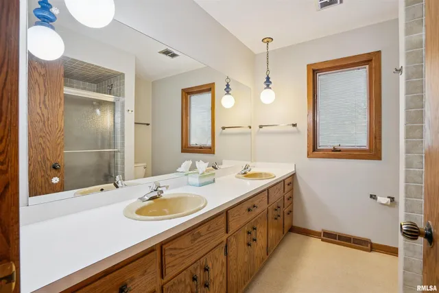 a bathroom with a sink double vanity and a mirror