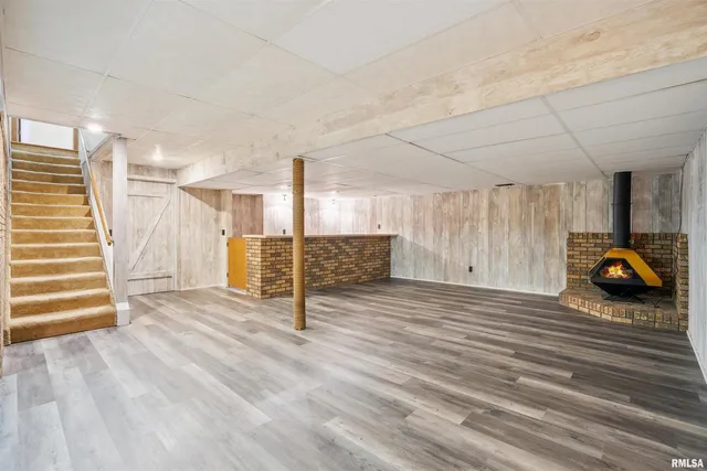 a view of a livingroom with wooden floor and furniture