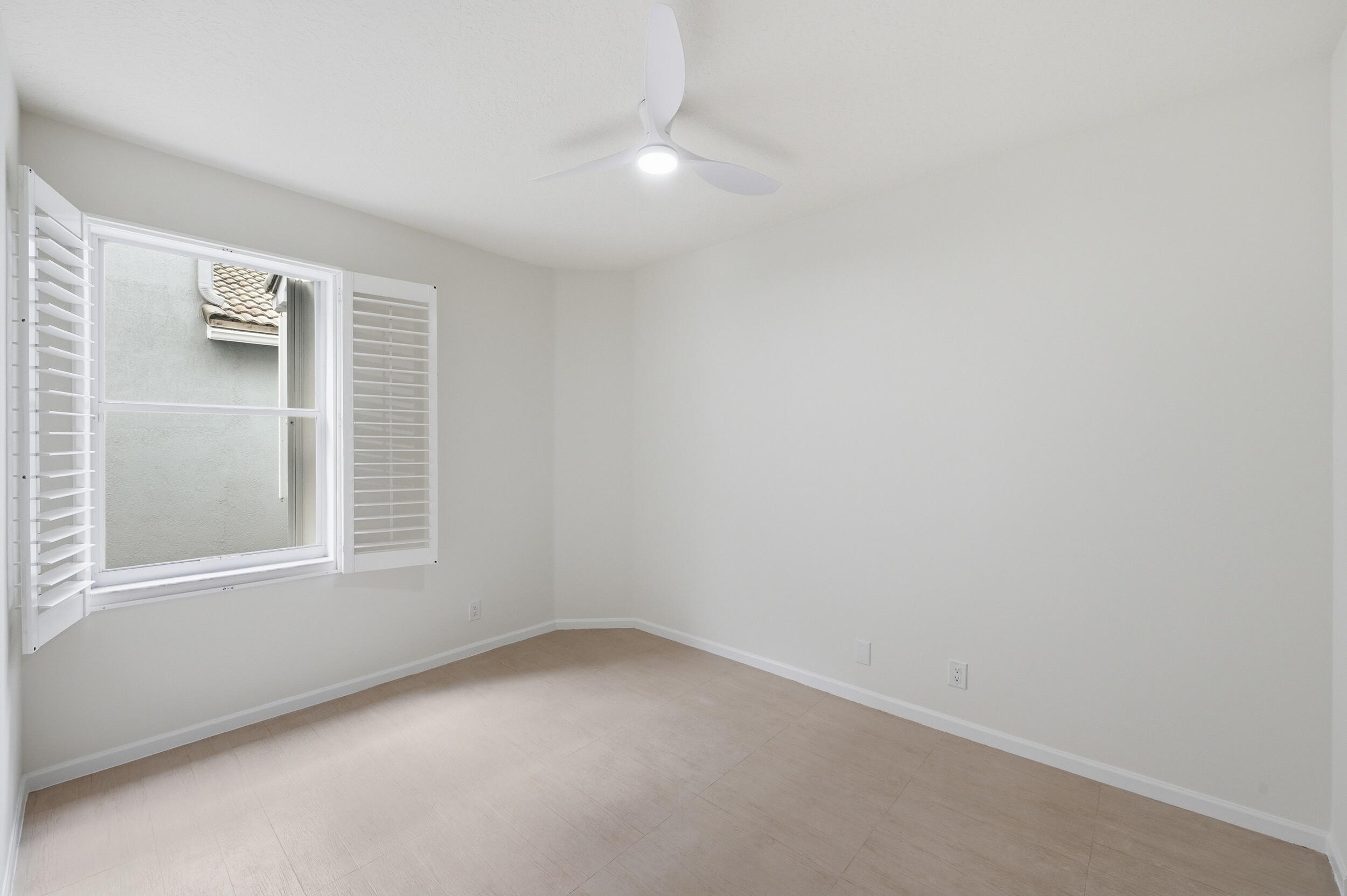8534 Vía D Oro Boca Raton, FL 33433 - Photo 29 of 34 an empty room with windows