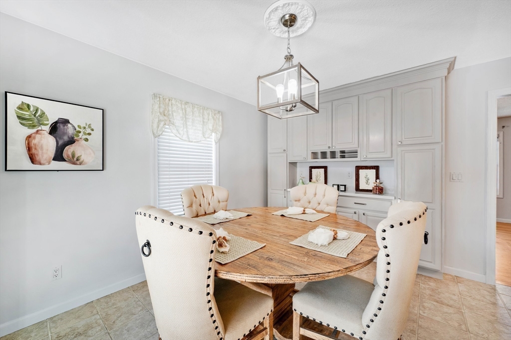 43 Martha Street Springfield, MA 01151 - Photo 12 of 32 a view of a dining room with furniture a chandelier and wooden floor