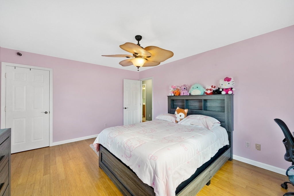 43 Martha Street Springfield, MA 01151 - Photo 21 of 32 a bedroom with a bed and a chandelier