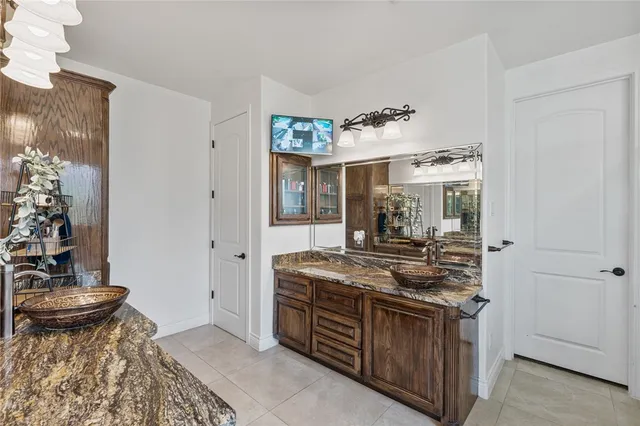 a bathroom with a tub sink shower and mirror