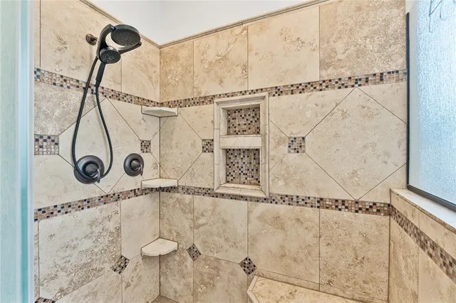 a bedroom with a bed a chandelier and a closet