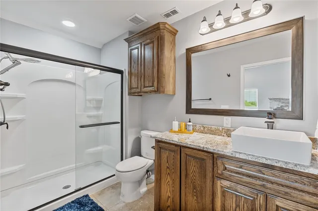 a bedroom with a bed and a flat tv screen on dresser