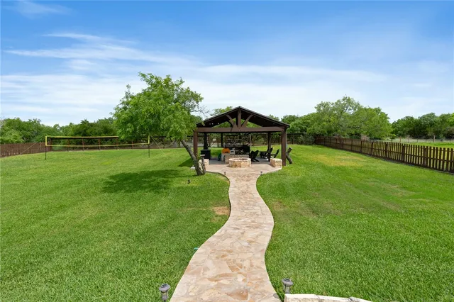 a view of a house with backyard porch and sitting area