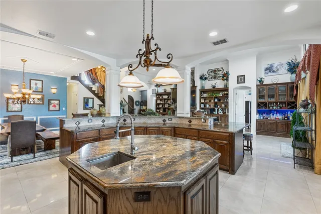 a view of a kitchen with stainless steel appliances granite countertop a stove and a sink