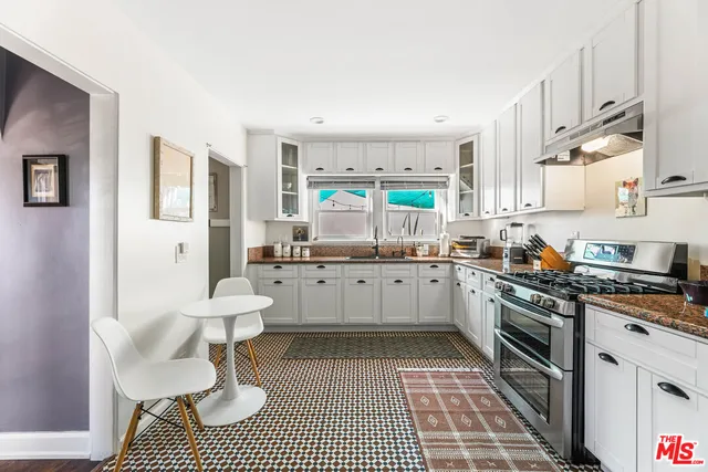 a kitchen with a stove a sink and a refrigerator
