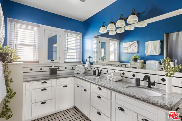 a kitchen with kitchen island granite countertop a sink a window and a counter space