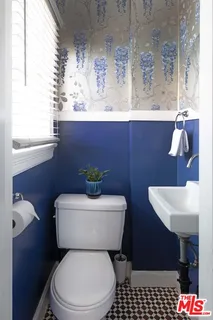 a bathroom with a toilet a sink and a window