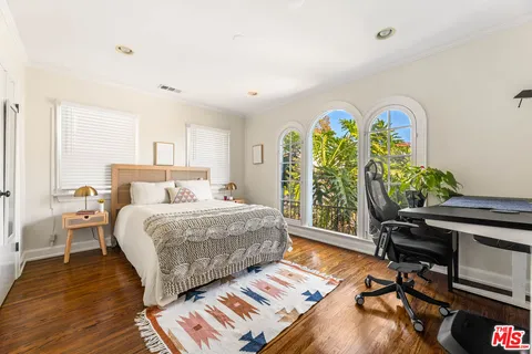 a bedroom with a bed and a desk