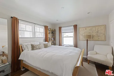 a bedroom with a large bed and a couch