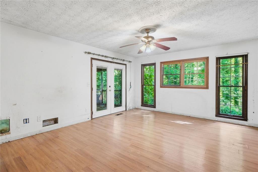 1453 Clearview Drive Northwest Acworth, GA 30102 - Photo 13 of 50 a view of an empty room with wooden floor and fan