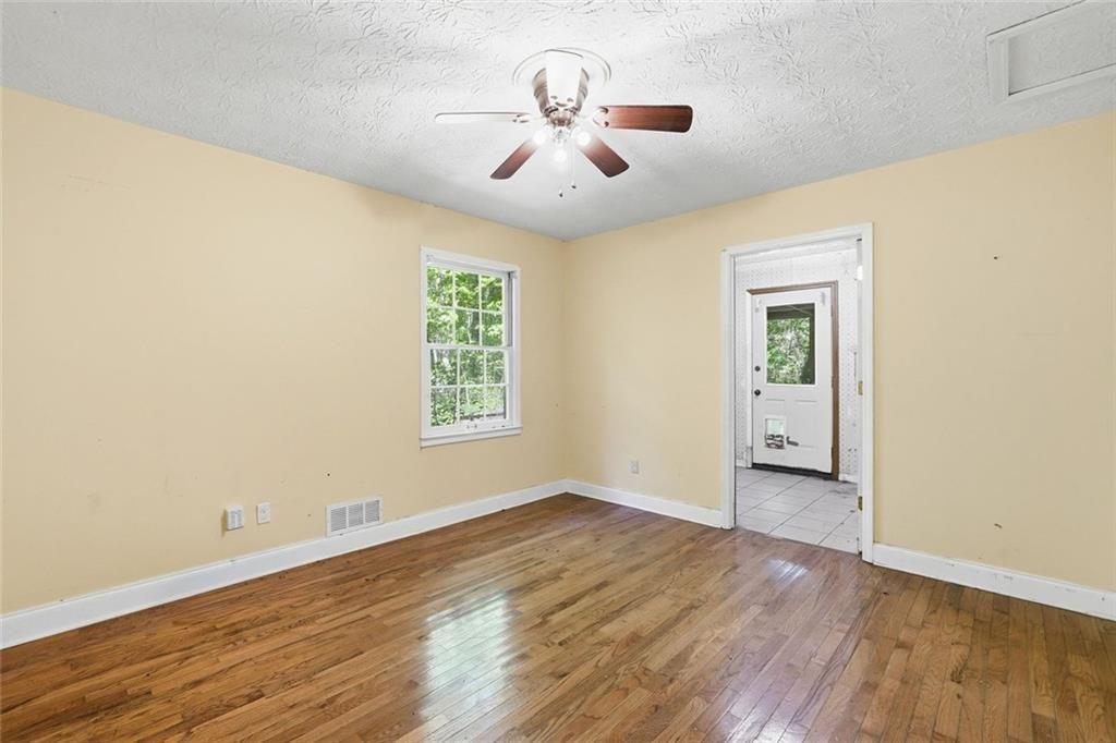 1453 Clearview Drive Northwest Acworth, GA 30102 - Photo 21 of 50 an empty room with wooden floor chandelier and windows