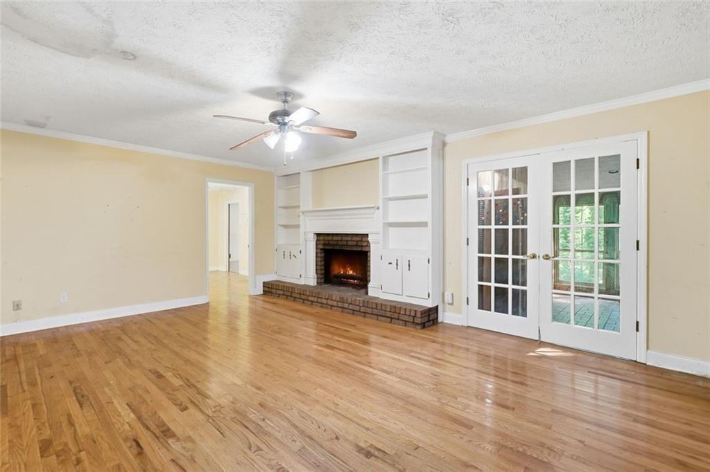 1453 Clearview Drive Northwest Acworth, GA 30102 - Photo 7 of 50 wooden floor fireplace and windows in an empty room