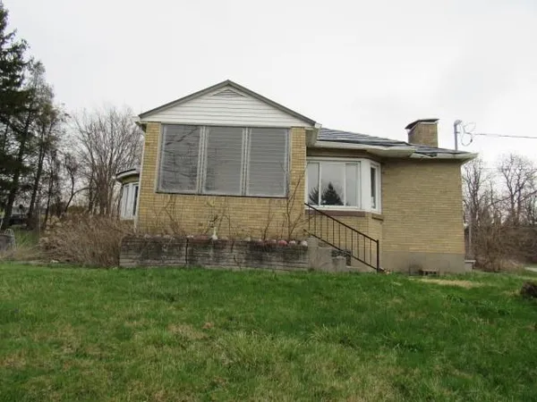 a brick house with garden in front of it