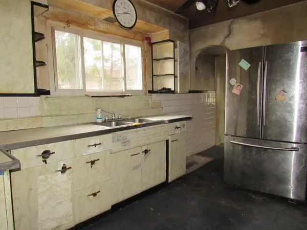 a kitchen with a refrigerator and a sink
