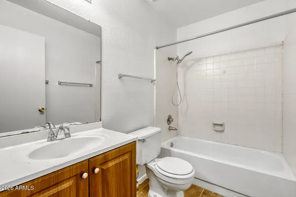 a bathroom with a sink toilet vanity and shower