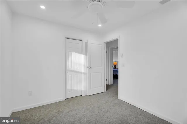 an empty room with an entryway and closet