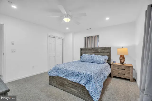 a bedroom with a bed and a lamp