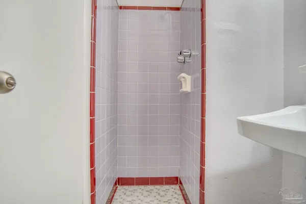 a bathroom with a shower and a sink