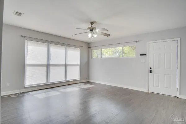 wooden floor in an empty room with a window
