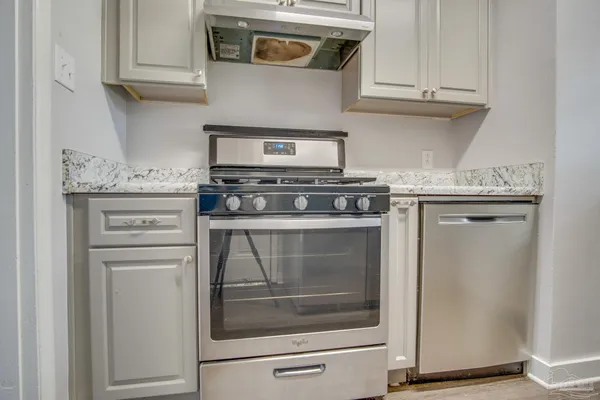 a stove top oven sitting inside of a kitchen