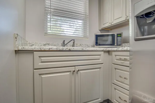a kitchen with appliances cabinets and a window