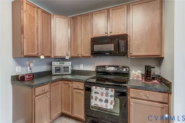a kitchen with kitchen island granite countertop a stove refrigerator and microwave