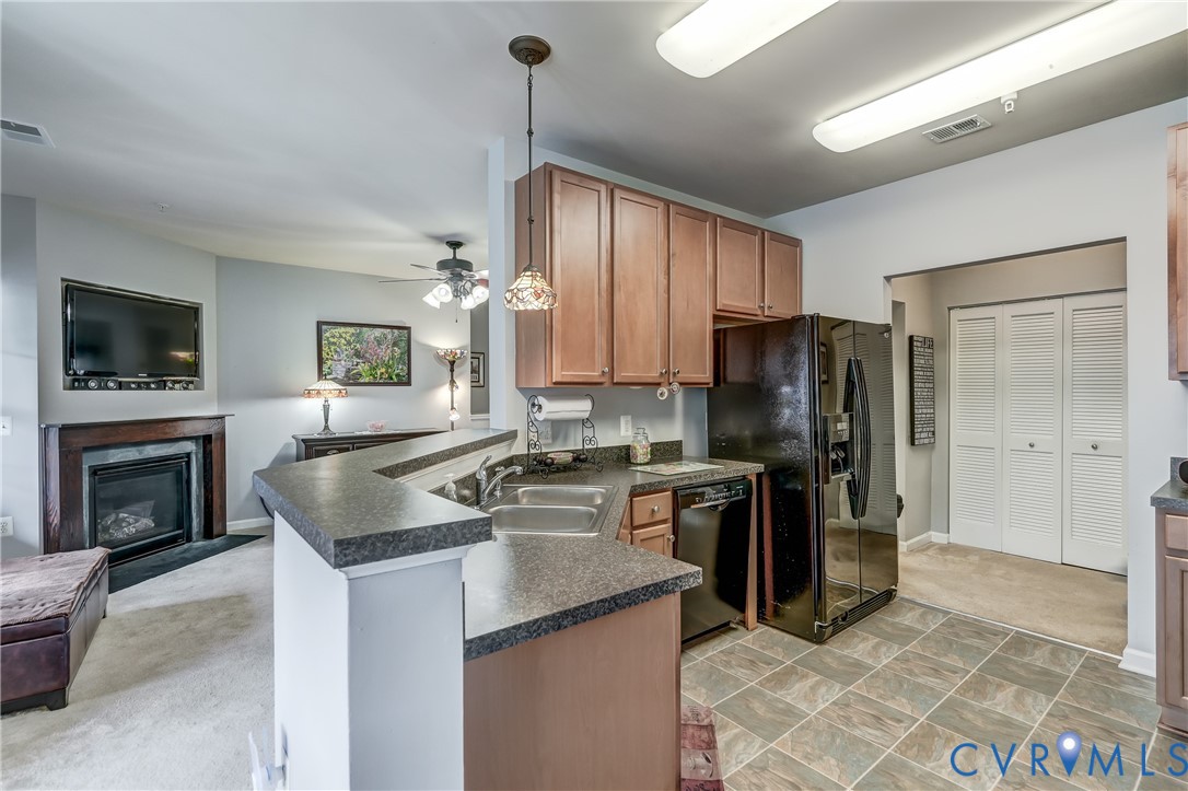 14010 Briars Circle, Unit 204 Midlothian, VA 23114 - Photo 13 of 40 a kitchen with kitchen island granite countertop a stove refrigerator and microwave