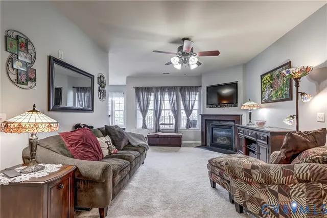 a living room with furniture a chandelier and a flat screen tv