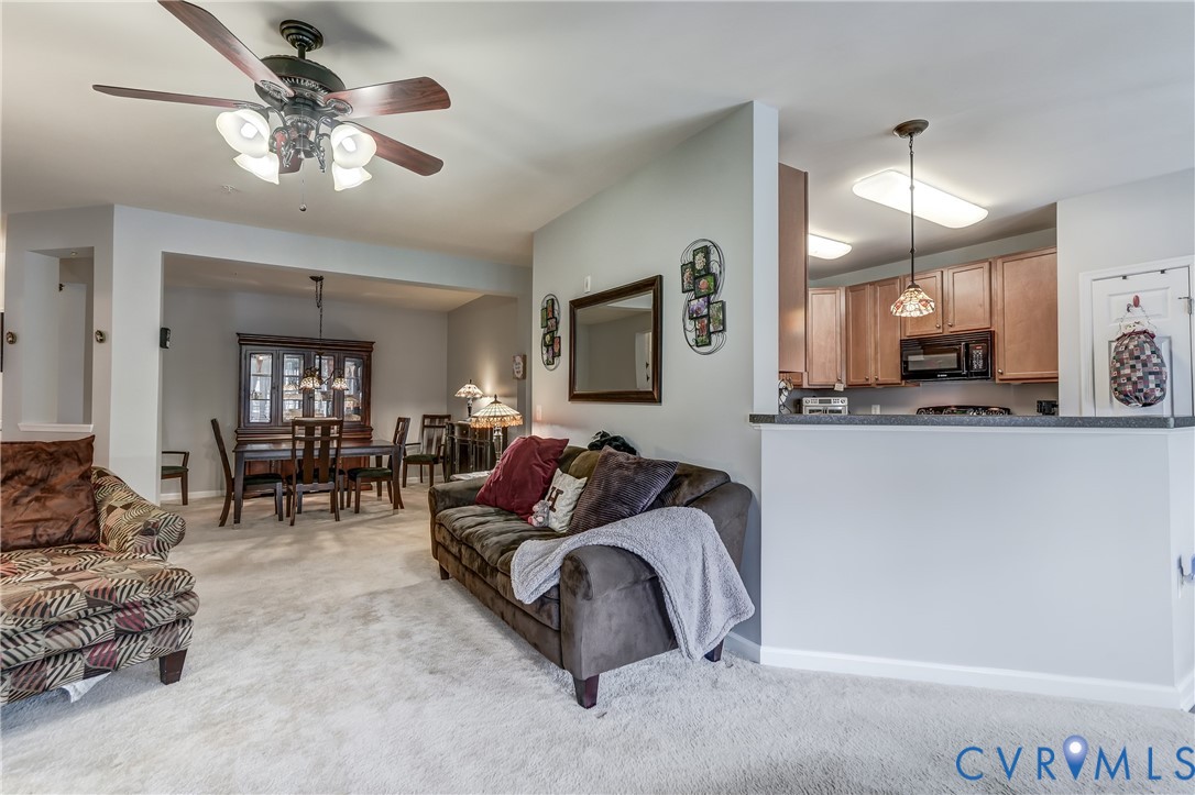 14010 Briars Circle, Unit 204 Midlothian, VA 23114 - Photo 17 of 40 a living room with furniture a chandelier and a flat screen tv