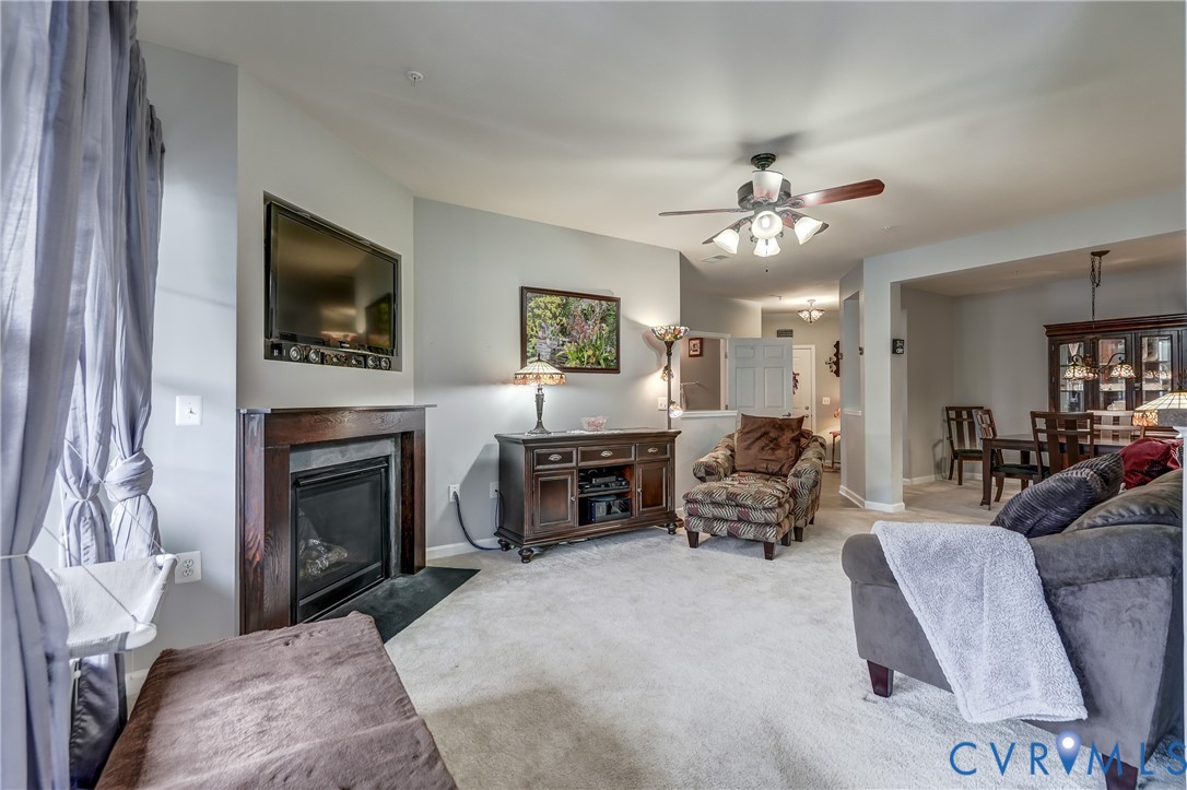 14010 Briars Circle, Unit 204 Midlothian, VA 23114 - Photo 18 of 40 a living room with furniture a fireplace and a flat screen tv