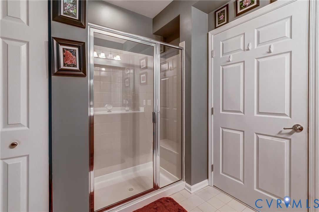 14010 Briars Circle, Unit 204 Midlothian, VA 23114 - Photo 23 of 40 a bathroom with a glass shower door