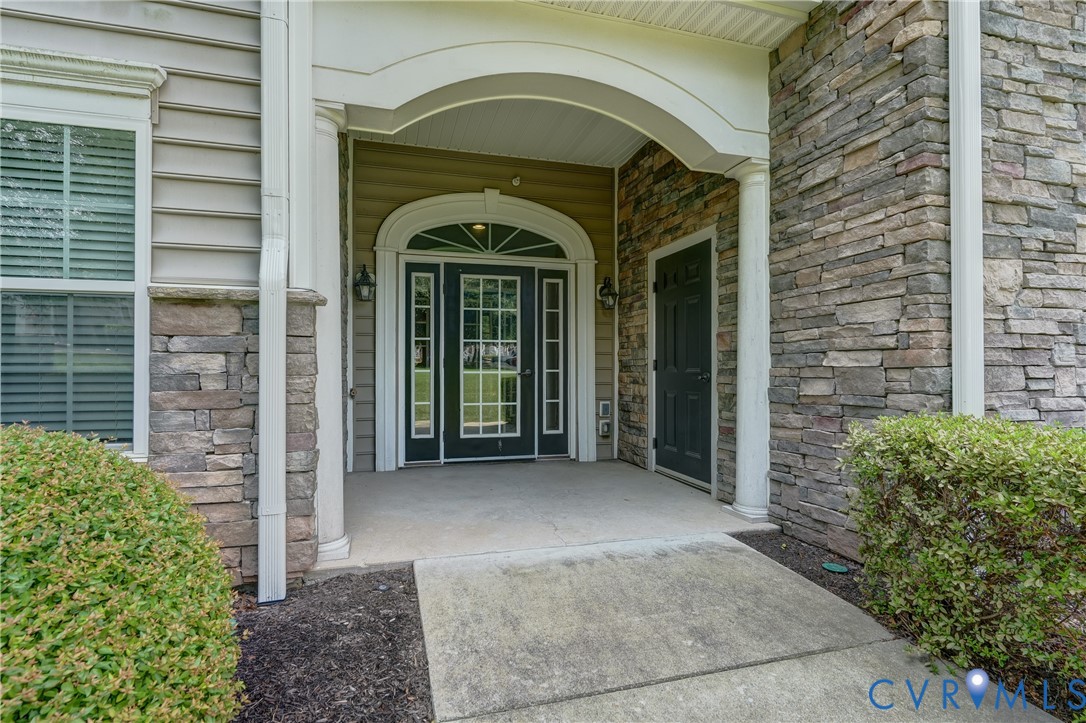 14010 Briars Circle, Unit 204 Midlothian, VA 23114 - Photo 32 of 40 a view of a brick house with potted plants