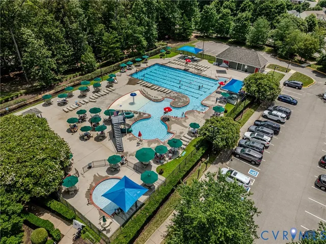 an aerial view of a house with swimming pool and outdoor seating