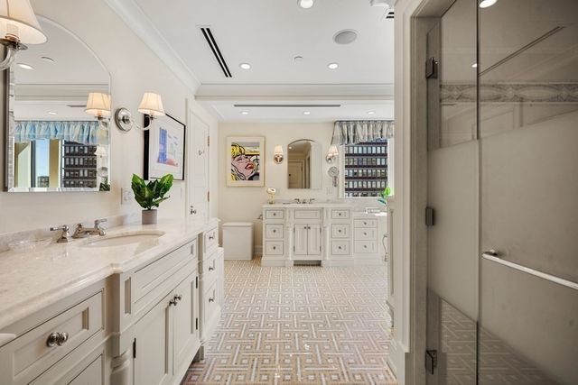 a spacious bathroom with a sink a mirror and a shower