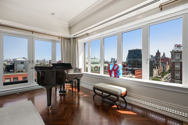 a room with furniture and floor to ceiling windows
