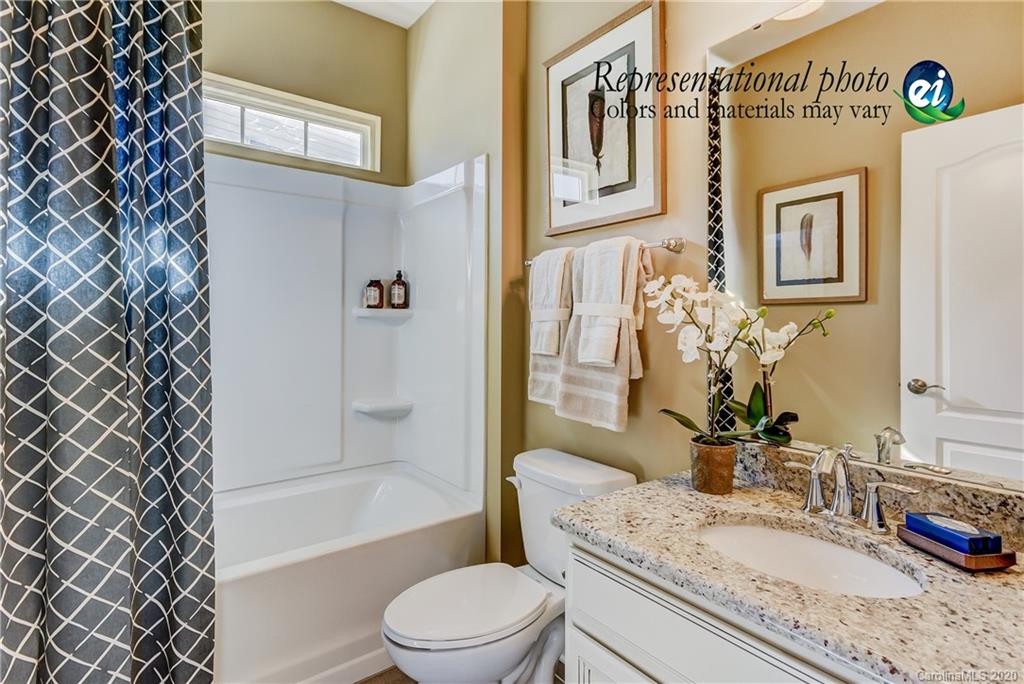 5116 Tranquility Boulevard, Unit 678 Lancaster, SC 29720 - Photo 13 of 21 a bathroom with a granite countertop bathtub sink vanity mirror and toilet