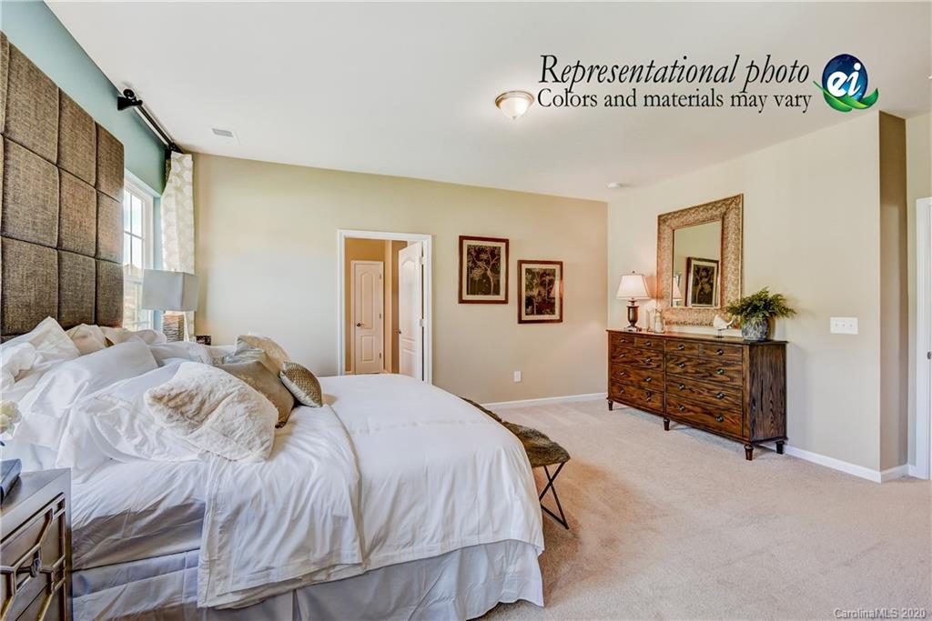 5116 Tranquility Boulevard, Unit 678 Lancaster, SC 29720 - Photo 21 of 21 a spacious bedroom with a bed and a cabinets