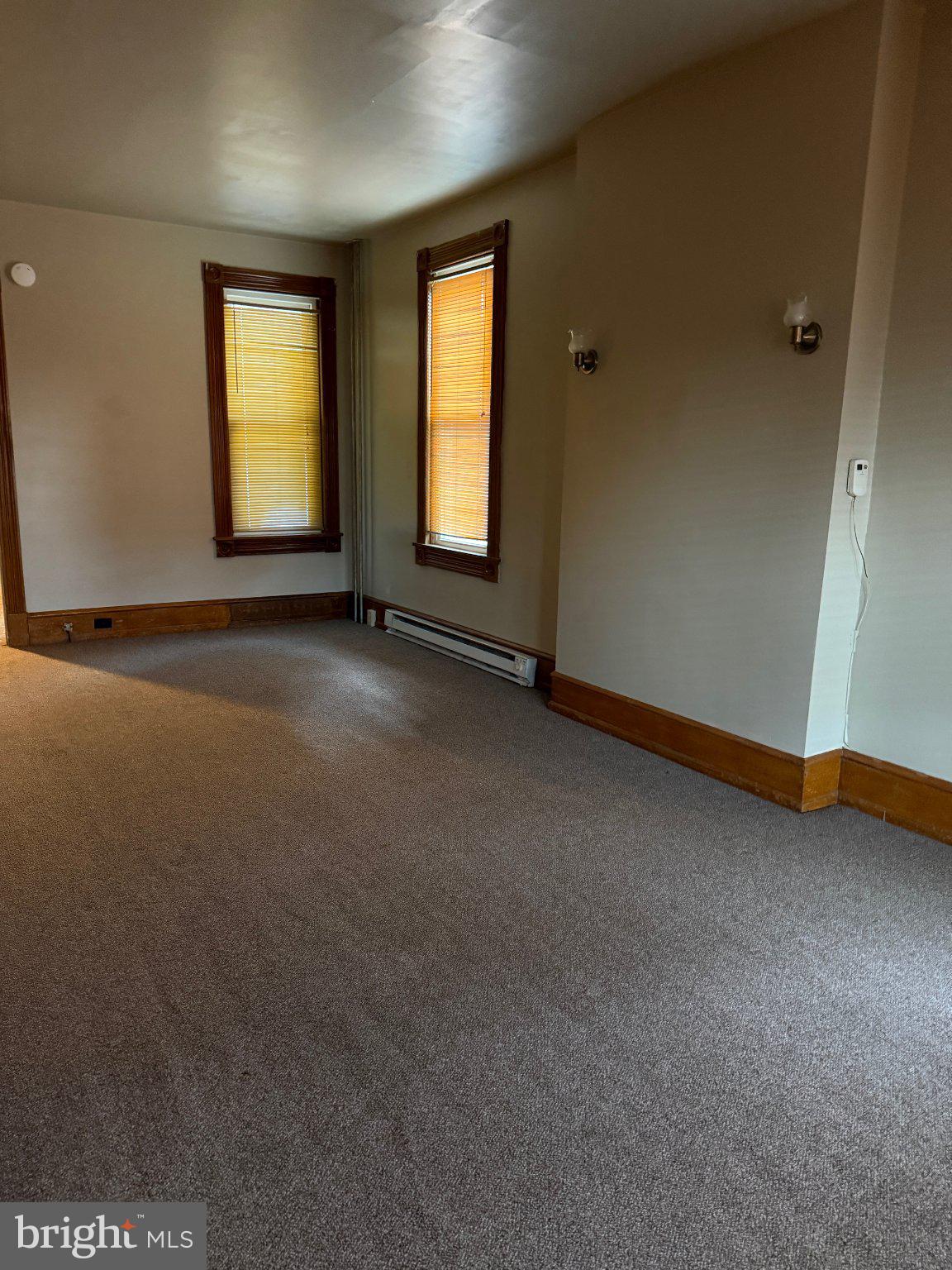 Spacious room with warm natural light.