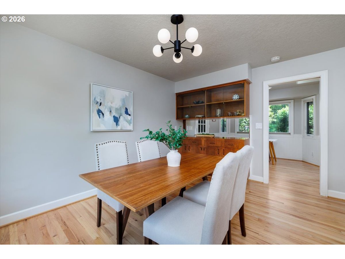 175 Northwest 95th Avenue Portland, OR 97229 - Photo 9 of 46 a view of a dining room with furniture and wooden floor