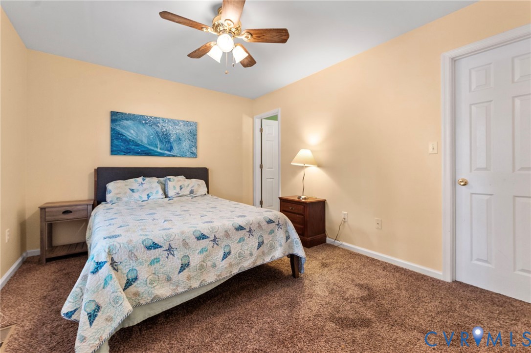 1120 South Glebe Road Montross, VA 22520 - Photo 14 of 29 a bedroom with a bed and a chandelier