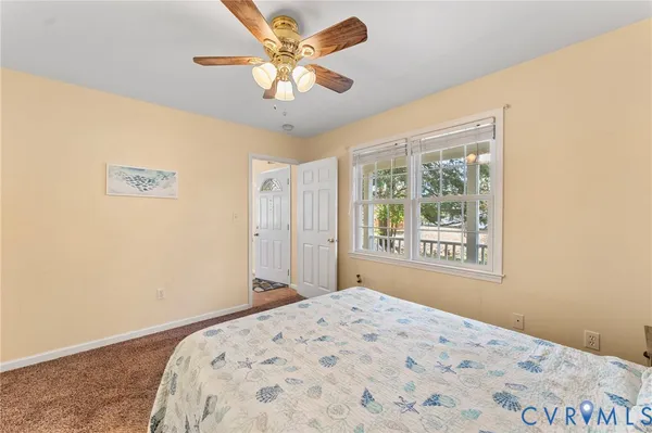 a bedroom with a large bed and a window