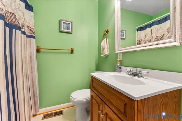 a bathroom with a sink mirror and toilet