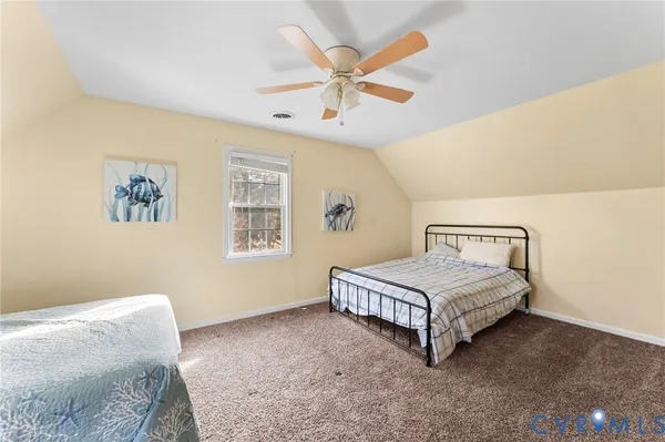a spacious bedroom with a bed and a ceiling fan