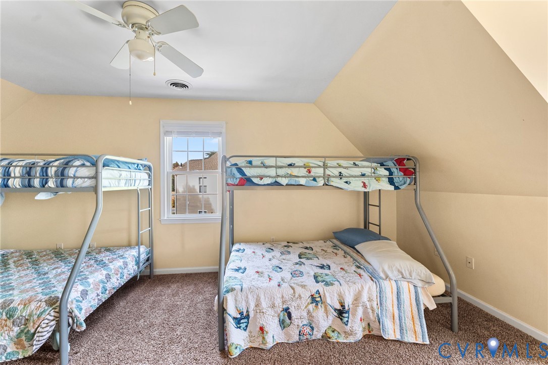 1120 South Glebe Road Montross, VA 22520 - Photo 23 of 29 a bedroom with a bed and a chandelier